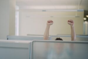 Exuberant Man in Office Cubicle