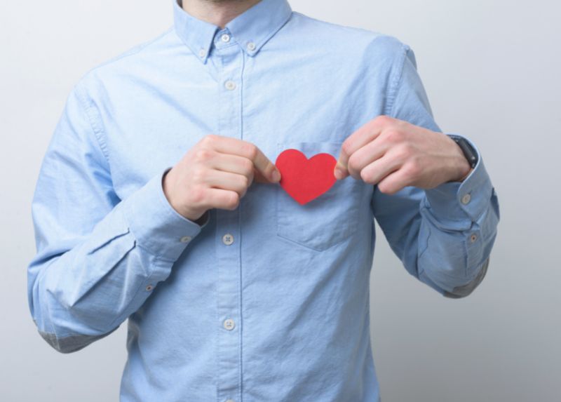 Man holding paper heart