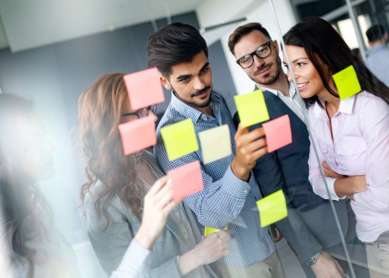 Team workshopping with post it notes