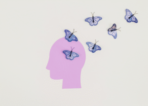 Purple paper cutout of a human head with blue butterflies flying out