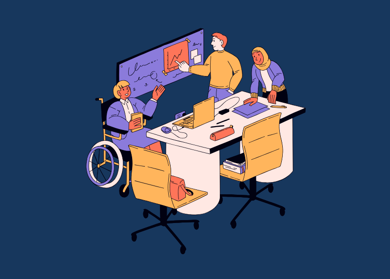 Diverse team collaborating around a table with a wheelchair user and colleagues working together on ideas and a presentation.
